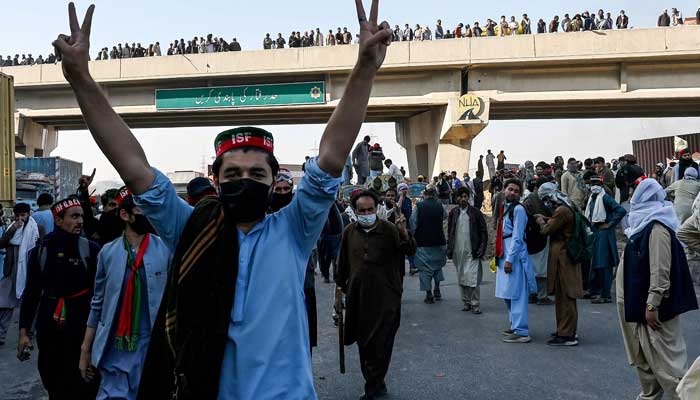 PTI supporters march towards Islamabad after clearing shipping containers placed by authorities at Hasan Abdal in Punjab on November 25, 2024. — Reuters