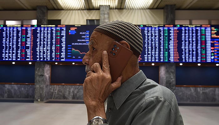 A stockbroker monitors the share prices during a trading session at the PSX in Karachi, on December 18, 2023. — INP