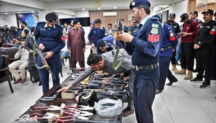 Police officials showing the weapons allegedly recovered from PTI protestors during press conference at PID Media Center in Islamabad on November 27, 2024. —APP