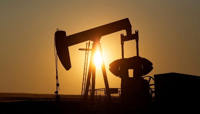 An oil pump jack pumps oil in a field near Calgary, Alberta, Canada on July 21, 2014. — Reuters