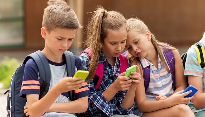 A representational image of school children using phones. — AFP