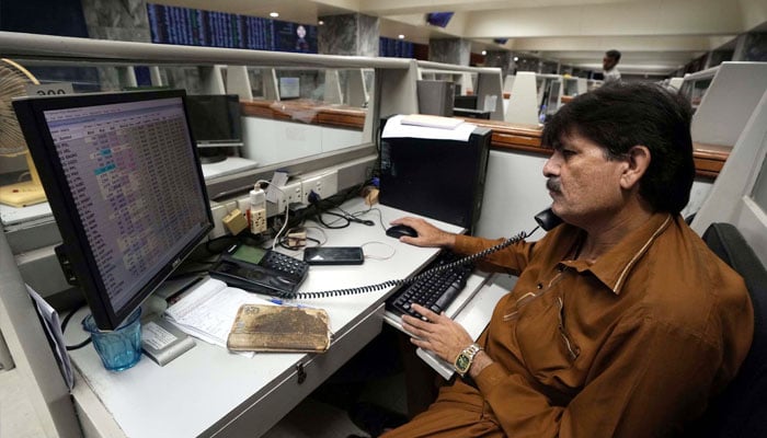 A broker talks on the phone at the Pakistan Stock Exchange in Karachi on May 20, 2024. — PPI