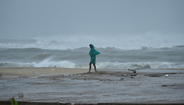 A man walks along the Neelankarai beach during high tide before cyclone Fengal approaches in Chennai, India November 30, 2024. — Reuters