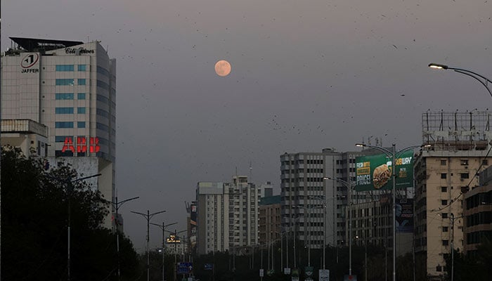 Representational image shows the moon shining on the sky as night falls on Karachi on November 15, 2024. — Reuters