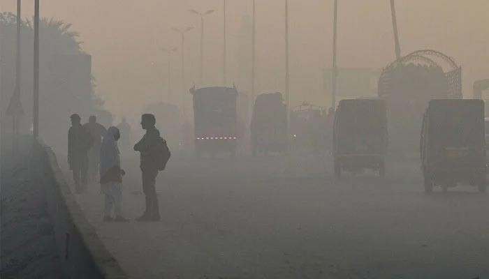 Vehicles move on road amid heavy smog conditions in Lahore in this undated image. — AFP/File