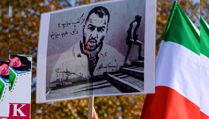 People hold placards bearing portraits of Iranian rapper Toomaj Salehi during a rally in support of Iranian women in Istanbul, on November 26, 2022. — AFP