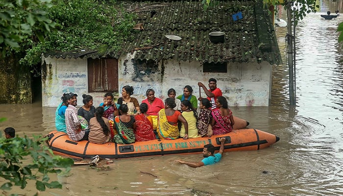 Volunteers rescue residents through a flooded street after heavy rainfall in Puducherry on December 2, 2024, following the landfall of Cyclone Fengal in India´s state of Tamil Nadu. — AFP