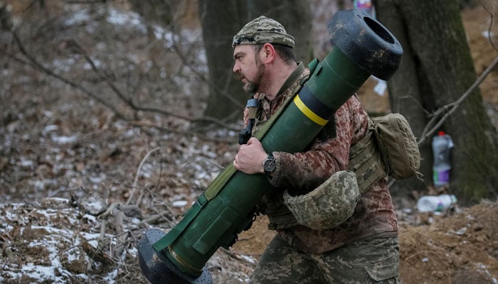 A Ukrainian service member holds a Javelin missile system at a position on the front line in the north Kyiv region, Ukraine March 13, 2022. — Reuters