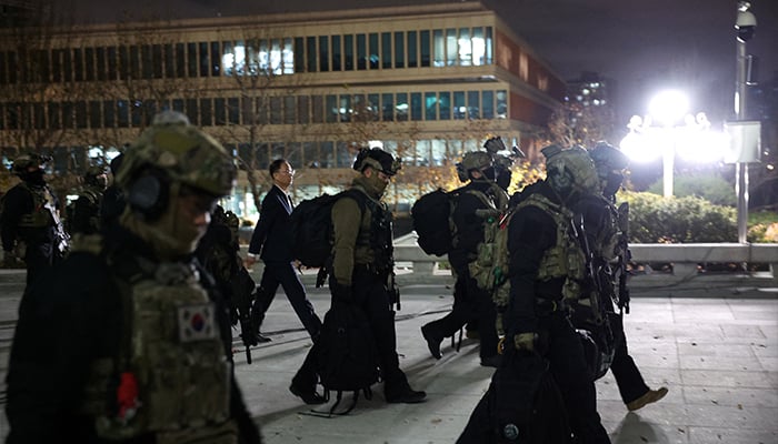 Military forces walk outside the National Assembly, after South Korean President Yoon Suk Yeol declared martial law, in Seoul, South Korea, December 4, 2024. — Reuters