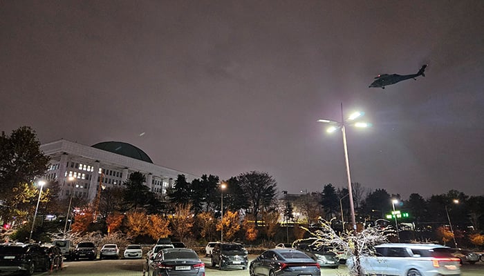 A helicopter flies around the National Assembly hall after South Korean President Yoon Suk Yeol declared martial law in Seoul, South Korea, December 3, 2024. — Reuters