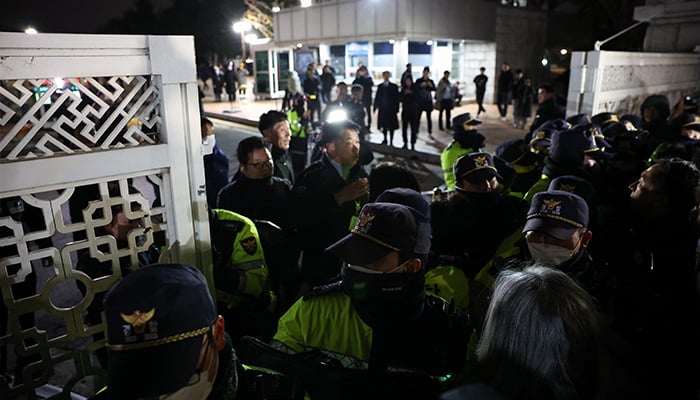 Police officers close the gate of the National Assembly, after South Korean President Yoon Suk Yeol declared martial law, in Seoul, South Korea, December 4, 2024. — Reuters