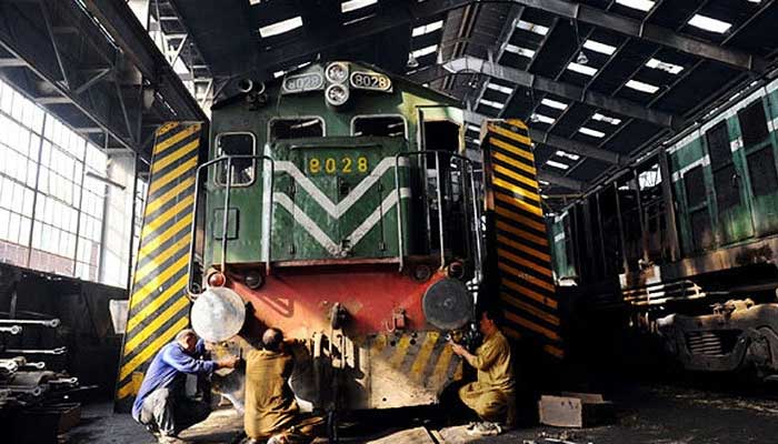 A representational image showing technicians working on a Pakistan Railways engine bogie. — AFP/File