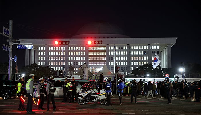 Police officers keep watch outside the National Assembly, after South Korean President Yoon Suk Yeol declared martial law, in Seoul, South Korea, December 4, 2024. — Reuters