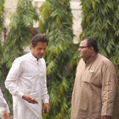 Founder of PTI Imran Khan alongside former PTI media coordinator Javed Bader. — X @jkhanbadar