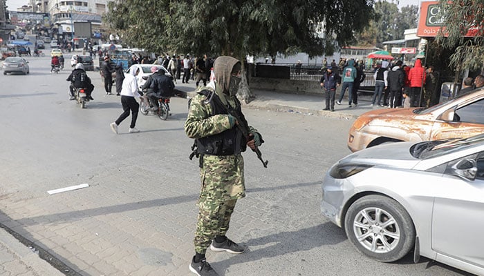 A rebel fighter holds a weapon, after rebels led by HTS have sought to capitalize on their swift takeover of Aleppo in the north and Hama in west-central Syria by pressing onwards to Homs, in Hama, Syria December 6, 2024. — Reuters