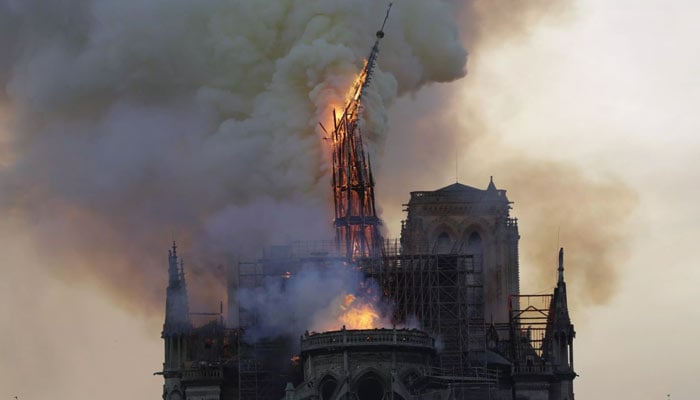 The image of the spire in flames crashing to the ground made front-page news around the world. — AFP