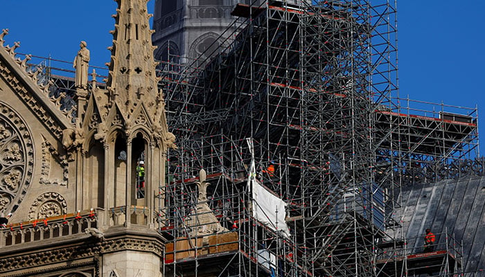 Construction workers are seen on scaffolding at the Notre-Dame de Paris Cathedral, which was ravaged by a fire in 2019, as restoration works continue before the reopening ceremonies, in Paris, France, December 4, 2024. — AFP