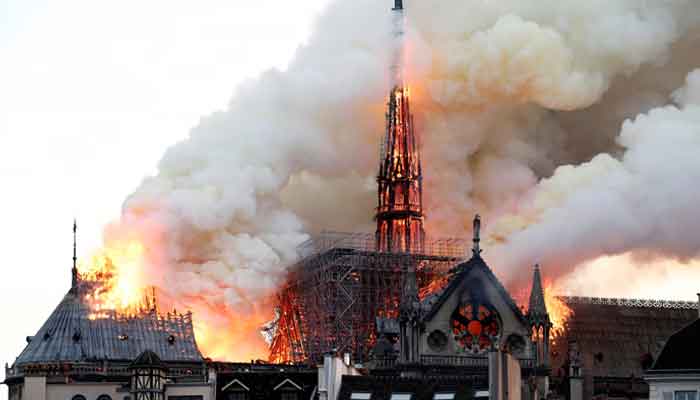 Smoke billows as fire engulfs the spire of Notre-Dame Cathedral in Paris, April 15, 2019. — Reuters