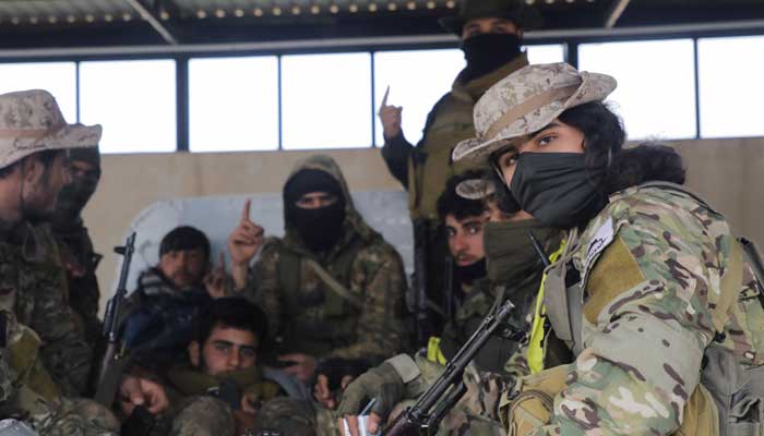 Rebel fighters sit together in Homs countryside, after Syrian rebels pressed their lightning advance on Saturday, saying they had seized most of the south, as government forces dug in to defend the key central city of Homs to try to save President Bashar al-Assads 24-year rule, in Syria December 7, 2024. — Reuters