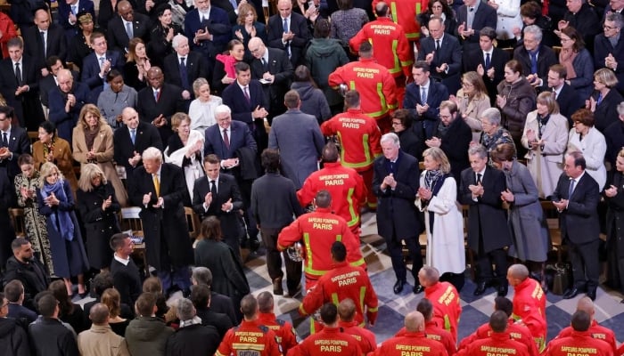 Firefighters who saved the 12th-century landmark during a 2019 blaze recieve a standing ovation, Notre-Dame Cathedral, Paris, December 7, 2024. — Reuters