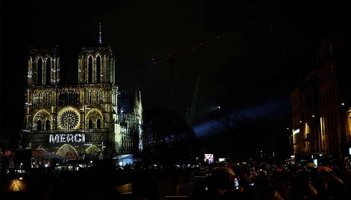 The word Thank you is seen on the facade of the Notre-Dame de Paris Cathedral during a light show for its reopening service ceremony, five-and-a-half years after a fire ravaged the Gothic masterpiece, as part ceremonies to mark the Cathedrals reopening after its restoration, in Paris, France, December 7, 2024. — Reuters