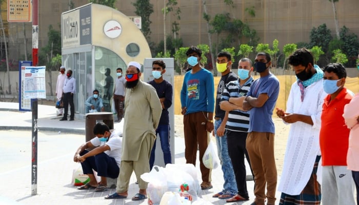 Workers wear protective face masks during the coronavirus pandemic in Dubai, UAE, April 23, 2020. — Reuters