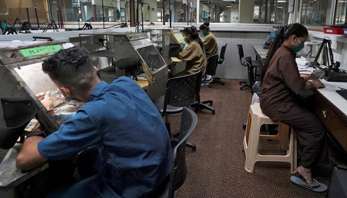 Employees work at a diamond jewellery manufacturing factory in Mumbai, India, August 7, 2020. — Reuters