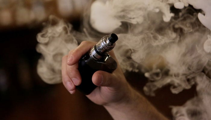 A man holds an electronic cigarette as he vapes at a Vape Shop in Monterrey, Mexico February 1, 2019. Picture taken February 1, 2019. — Reuters