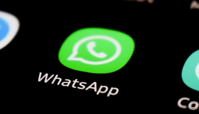 A representational image shows the WhatsApp icon displayed on a phone screen. — Unsplash