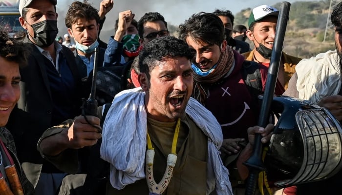 Pakistan Tehreek-e-Insaf (PTI) supporters shout slogans as they protest to demand the release of former prime minister Imran Khan, in Hasan Abdal, on November 25. —AFP