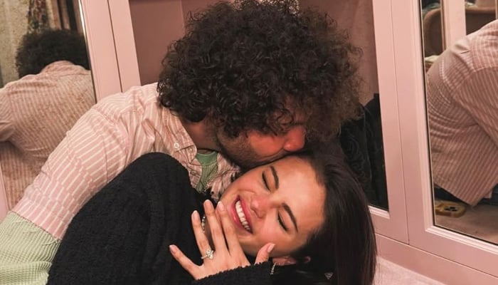 Newly engaged Selena Gomez cant stop gazing at her huge engagement ring