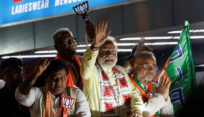 Indias Prime Minister Narendra Modi waves towards his supporters during a roadshow as part of an election campaign, in Kolkata, India, May 28, 2024. — Reuters