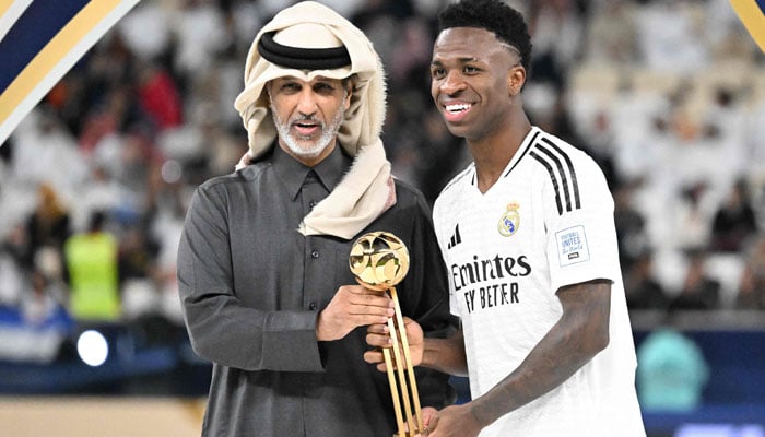 Qatars Sports and Youth Minister Sheikh Hamad bin Khalifa bin Ahmed al-Thani presents Real Madrids Brazilian forward #7 Vinicius Junior with the gold trophy during the podium ceremony after the 2024 FIFA Intercontinental Cup final football match between Spains Real Madrid and Mexicos Pachuca at the Lusail Stadium in Doha on December 18, 2024. — AFP