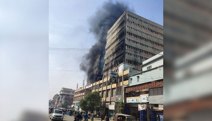 Smoke billows out of the first floor of Rimpa Plaza, located on MA Jinnah Road in Karachi on December 19, 2024. — Reporter