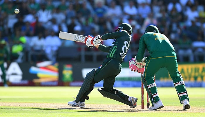 Pakistans Kamran Ghulam (L) hits a six during the second ODI match against South Africa at Newlands Cricket Ground, Cape Town on December 19, 2024. — AFP