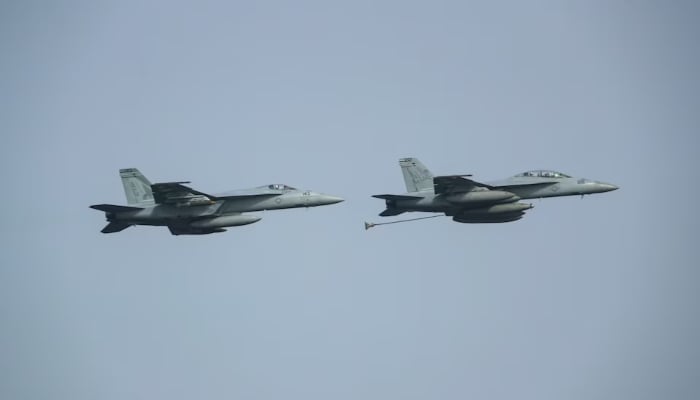 Two F/A-18 Super Hornets assigned to Carrier Air Wing 7 (CVW 7) demonstrate in-flight refueling during an Independence Day air power demonstration above the Nimitz-class aircraft carrier USS Abraham Lincoln (CVN 72), in Arabian Sea, July 4, 2019. — Reuters