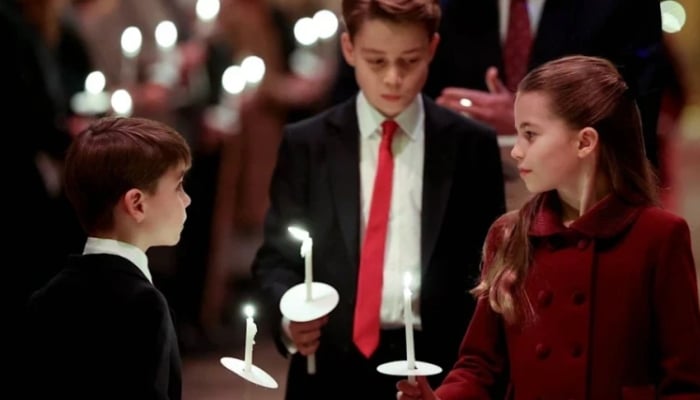 The candid image captures Louis looking up at his sister Charlotte with admiration