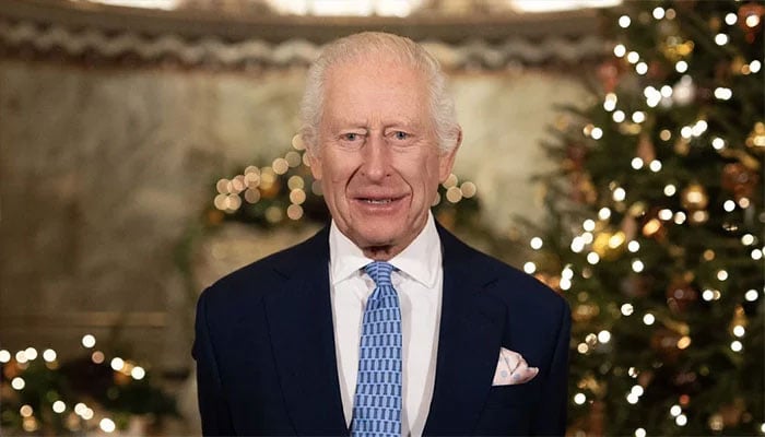 King Charles shares a secret smile in Christmas speech.