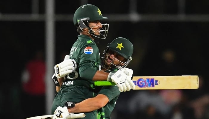 Saim Ayub and Salman Agha embrace after Ayub reached his hundred during first ODI between South Africa and Pakistan in Paarl on December 17, 2024. — AFP