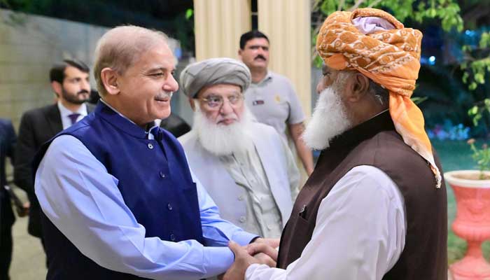 Prime Minister Shehbaz Sharif shakes hand with JUI-F chief Maulana Fazlur Rehman in Islamabad, on June 13, 2024. — PID