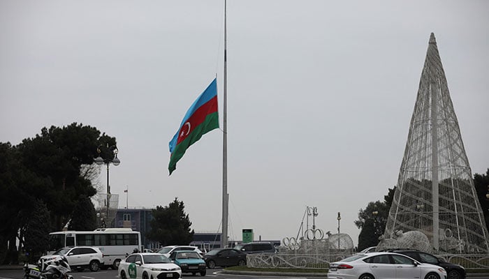 An Azeri state flag flies at half-mast as the country observes the day of national mourning for the victims of an Azerbaijan Airlines Embraer passenger plane crash near the Kazakh city of Aktau, in a square in Baku, Azerbaijan, December 26, 2024. — Reuters