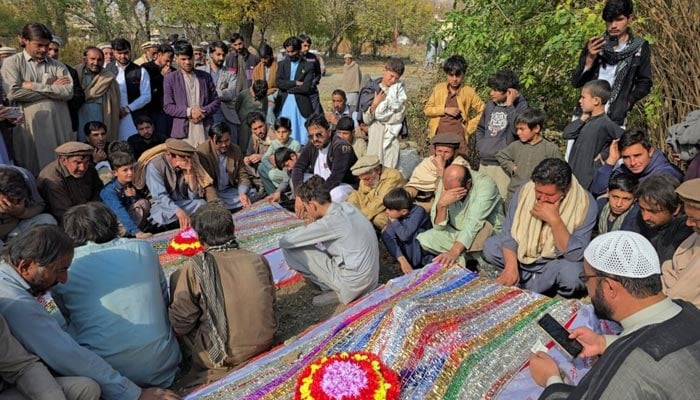 People mourn over the graves of relatives who were killed in fresh sectarian violence in Kurram on November 22, 2024. — Reuters