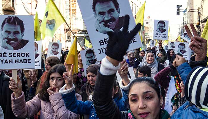 Protesters raise yellow flags and portraits showing the face of Abdullah Ocalan, the leader of the Kurdistan Worker´s Party (PKK), during a demonstration in Qamishli, Syria, February 15, 2023. — AFP