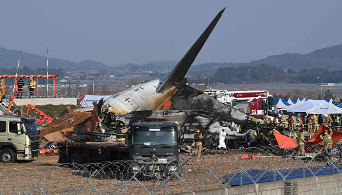 Firefighters and rescue personnel work near the wreckage of a Jeju Air Boeing 737-800 series aircraft after the plane crashed and burst into flames at Muan International Airport in South Jeolla Province on December 29, 2024. — AFP