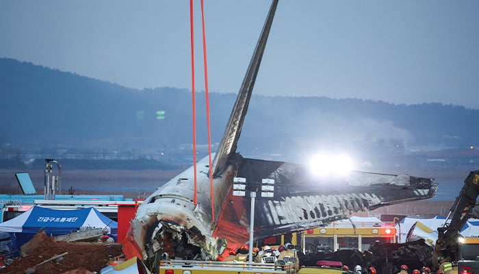 Efforts are made to lift the wreckage of an aircraft lying on the ground after it went off the runway and crashed at Muan International Airport, in Muan, South Korea, December 29, 2024. — Reuters