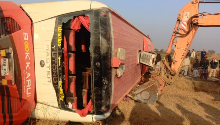 Rescue efforts are underway at the accident site near Fateh Jang where a bus overturned on December 30, 2024. — Reporter