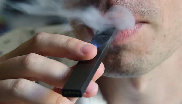 A representational image of a man smoking an e-cigarette. — AFP/File