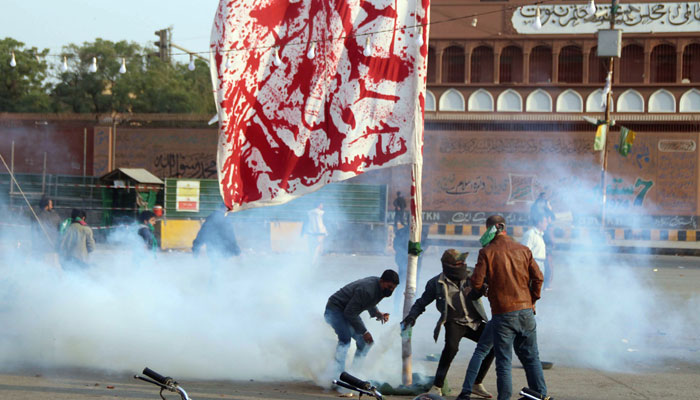 Protesters are pelting stones at police personnel during a clash at Karachi’s Numaish Chowrangi on December 31, 2024. — Online