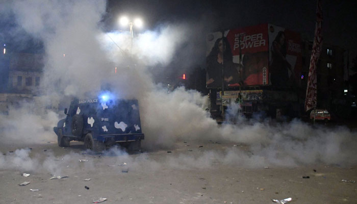 Police personnel fire tear gas shells at supporters of MWM during sit-in against Parachinar violence in Karachi on December 31, 2024. — Online