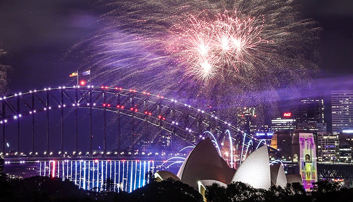 Fireworks light up the Sydney Harbour Bridge and Sydney Opera House during the early New Years Eve celebrations in Sydney on December 31, 2024. — AFP